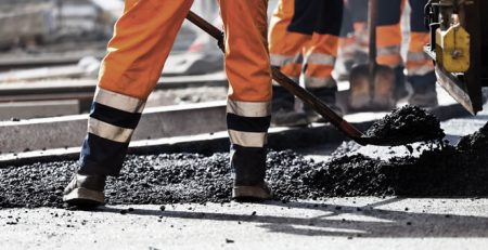 workers shoveling asphalt