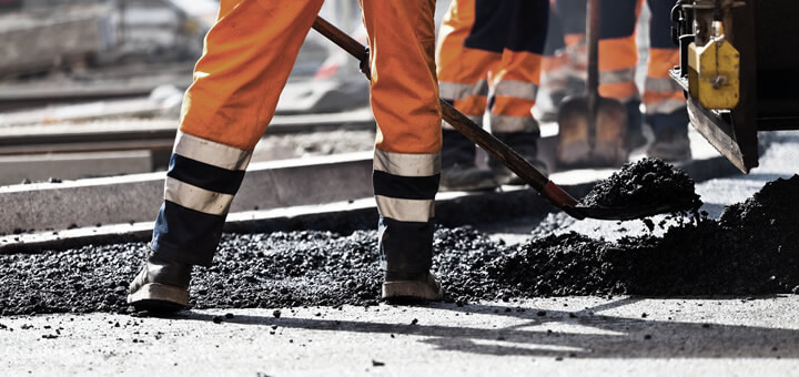 workers shoveling asphalt