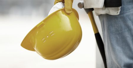 worker holding construction hat