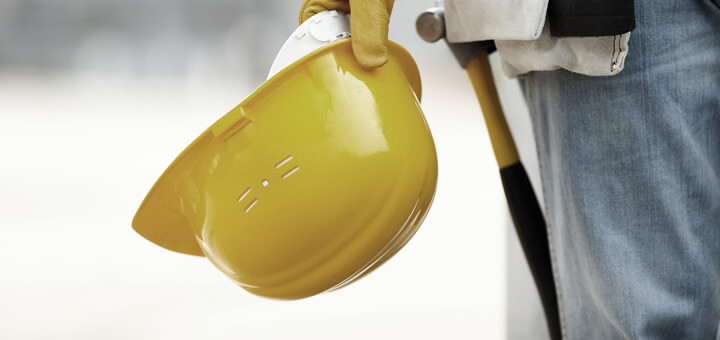 worker holding construction hat