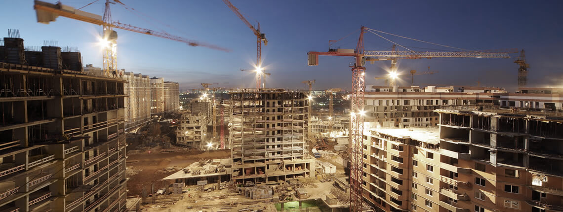 large commercial construction site with buildings and cranes