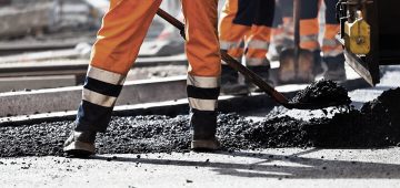 workers shoveling asphalt